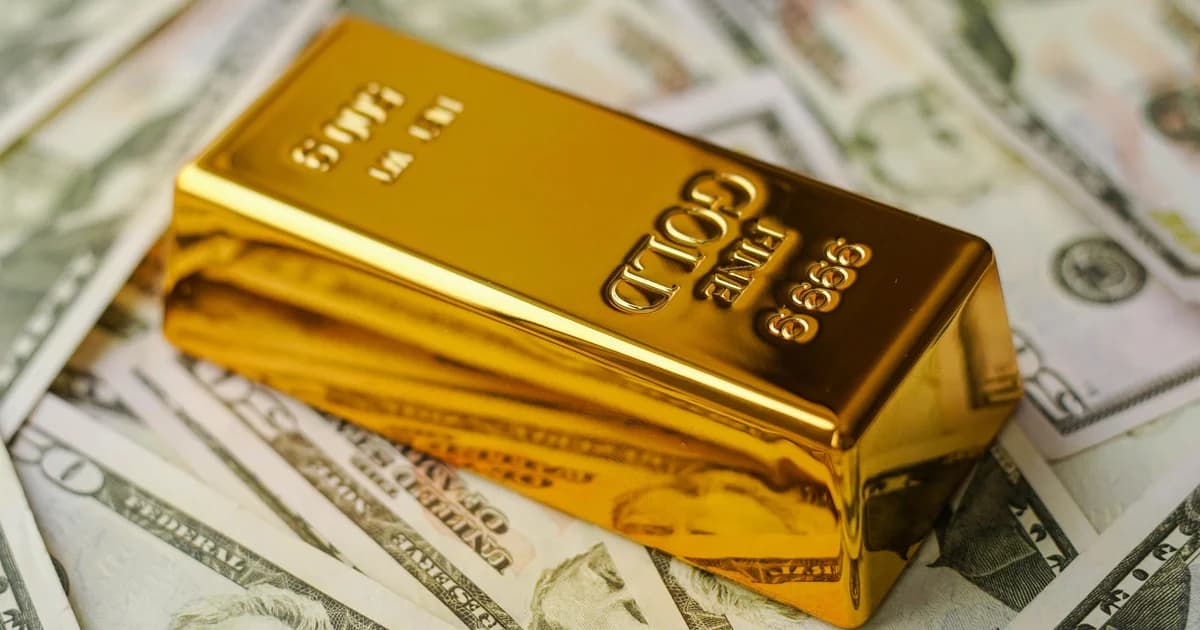 یک شمش طلای براق روی چند اسکناس ۵۰ دلاری